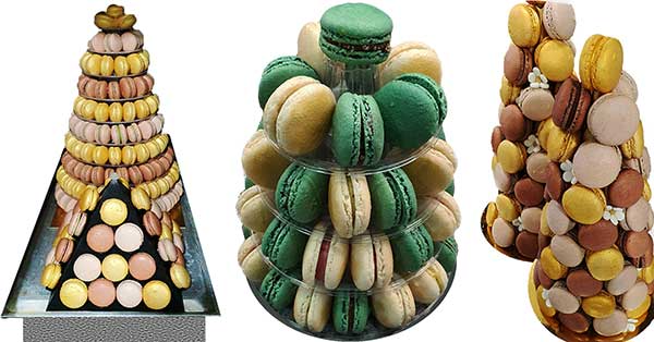 Estão expostas três torres de macarons: a primeira apresenta macarons em tons pastel empilhados num cone, a segunda tem macarons verdes e creme num suporte em camadas e a terceira apresenta guloseimas douradas, castanhas e cor-de-rosa - perfeitas para qualquer pastelaria fina.