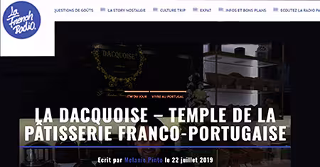 Captura de ecrã de um sítio Web que apresenta um artigo intitulado La Dacquoise - Temple de la pâtisserie franco-portugaise, com um fundo escuro e prateleiras com pastelaria e decorações, apresentando os destaques da imprensa Dacquoise.